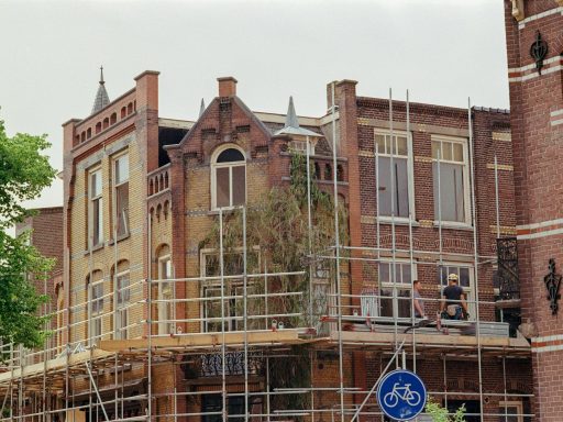 a building with scaffolding around it and a bicycle sign