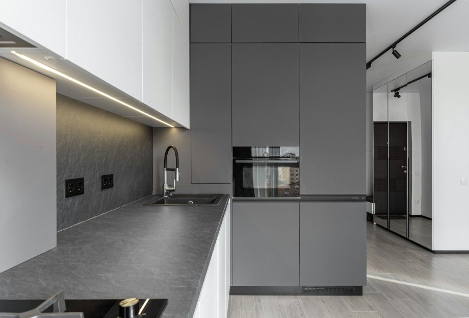 Modern kitchen features sleek gray cabinetry and design