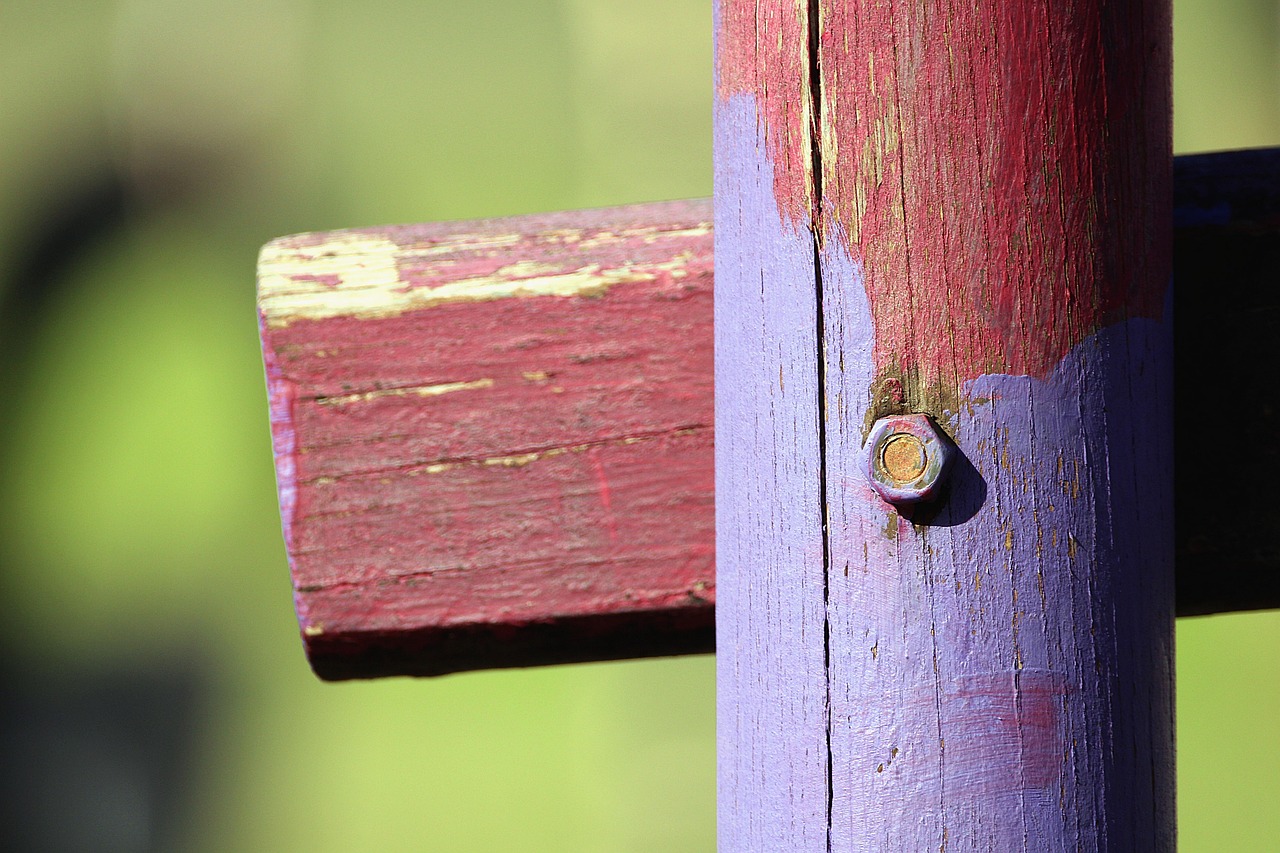 Houten tuinschutting die gerenoveerd wordt met kwast en beits